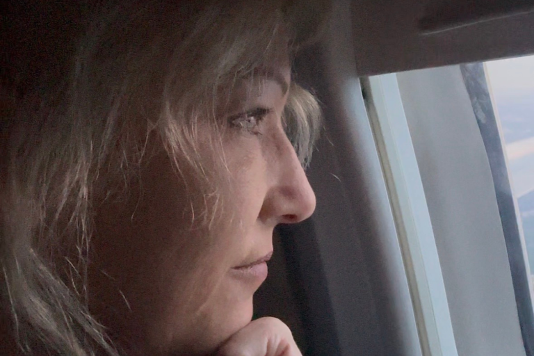 Mandy Staring out plane window, watching for her next destination
