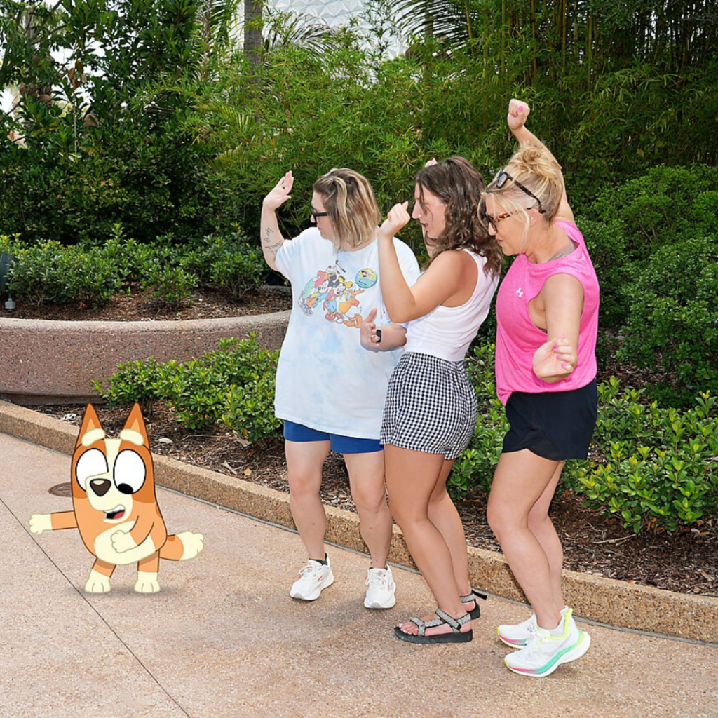 Mandy and her daughters in a pic dancing with Bluey at Epcot for Gracie's 21st bday