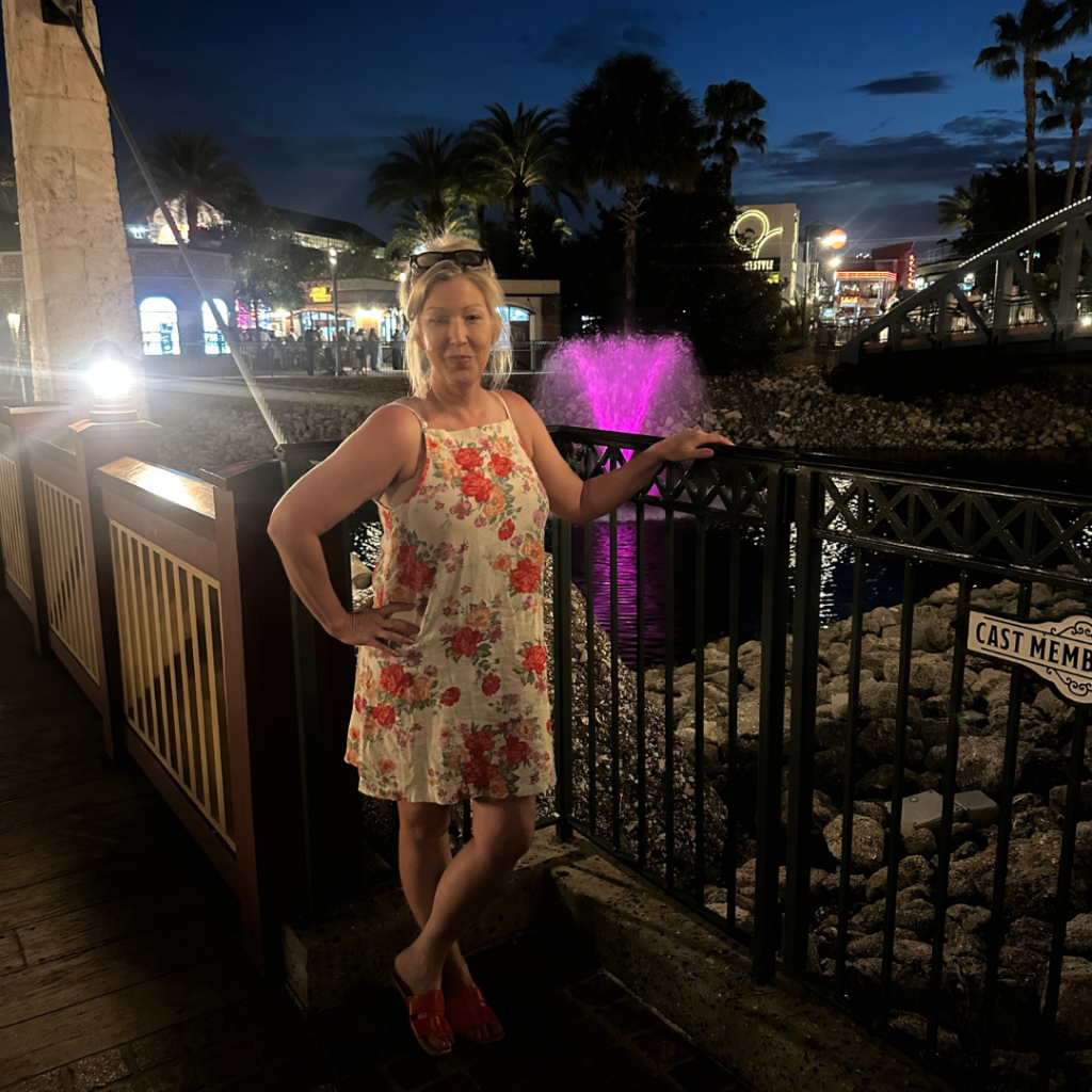 Mandy in a floral dress at Disney Springs at night